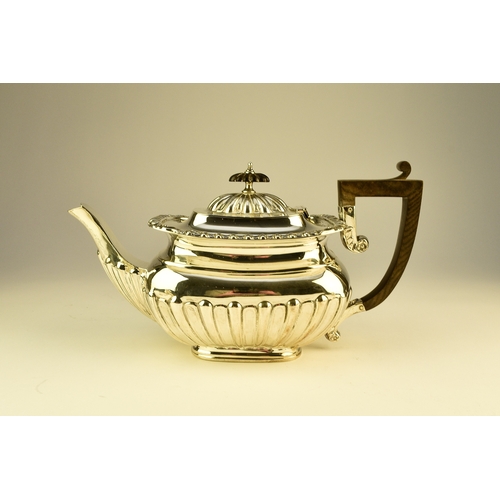 16 - An Edwardian three piece silver tea service, William Aitken, Birmingham 1907, each of rounded rectan... 