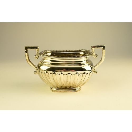 16 - An Edwardian three piece silver tea service, William Aitken, Birmingham 1907, each of rounded rectan... 