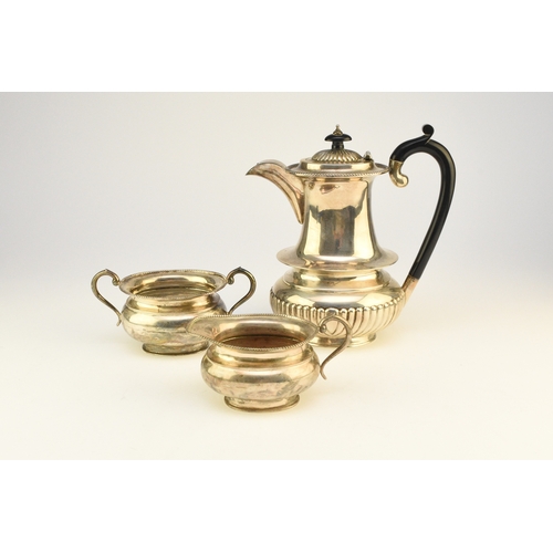 2 - A white metal hot water jug, of oval half reeded form with ebony handle and finial, 23.5cm high, rai... 