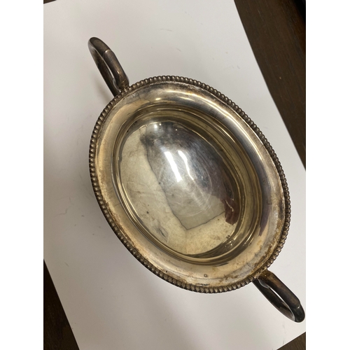 2 - A white metal hot water jug, of oval half reeded form with ebony handle and finial, 23.5cm high, rai... 