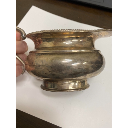 2 - A white metal hot water jug, of oval half reeded form with ebony handle and finial, 23.5cm high, rai... 