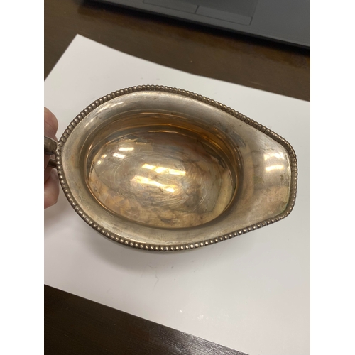 2 - A white metal hot water jug, of oval half reeded form with ebony handle and finial, 23.5cm high, rai... 