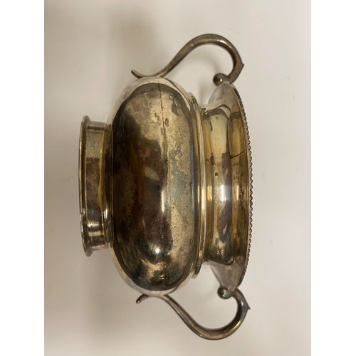 2 - A white metal hot water jug, of oval half reeded form with ebony handle and finial, 23.5cm high, rai... 