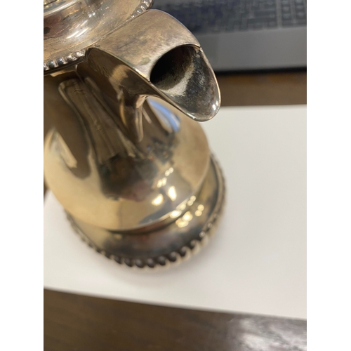 2 - A white metal hot water jug, of oval half reeded form with ebony handle and finial, 23.5cm high, rai... 