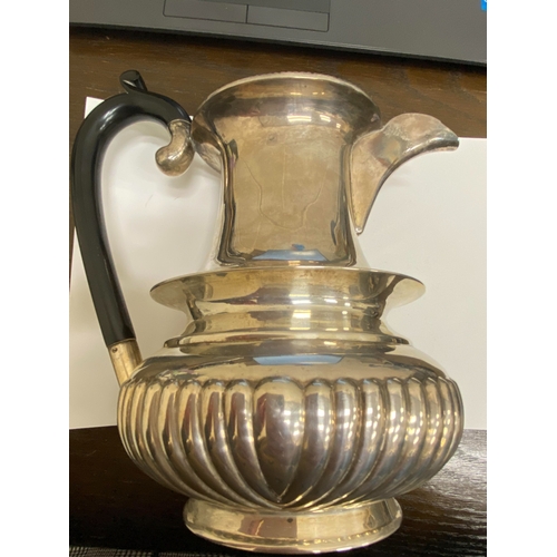 2 - A white metal hot water jug, of oval half reeded form with ebony handle and finial, 23.5cm high, rai... 