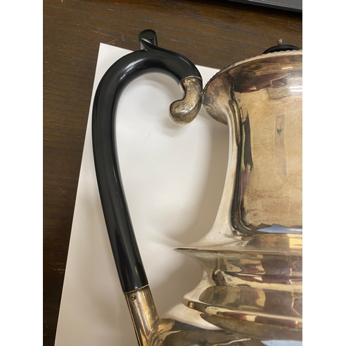 2 - A white metal hot water jug, of oval half reeded form with ebony handle and finial, 23.5cm high, rai... 