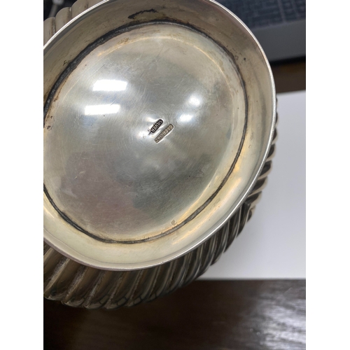 2 - A white metal hot water jug, of oval half reeded form with ebony handle and finial, 23.5cm high, rai... 