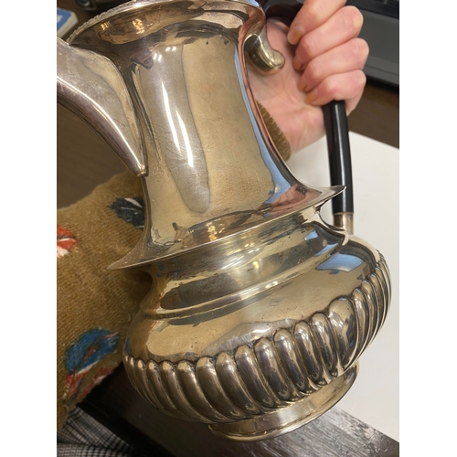 2 - A white metal hot water jug, of oval half reeded form with ebony handle and finial, 23.5cm high, rai... 