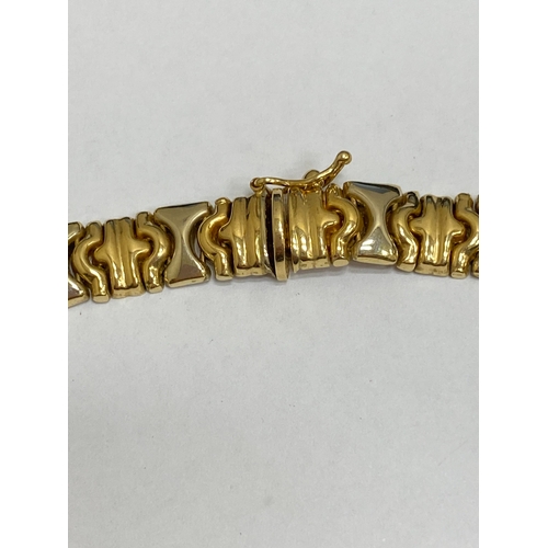 25 - A yellow and white metal decorative link collarette necklace, with integral clasp with attached safe... 