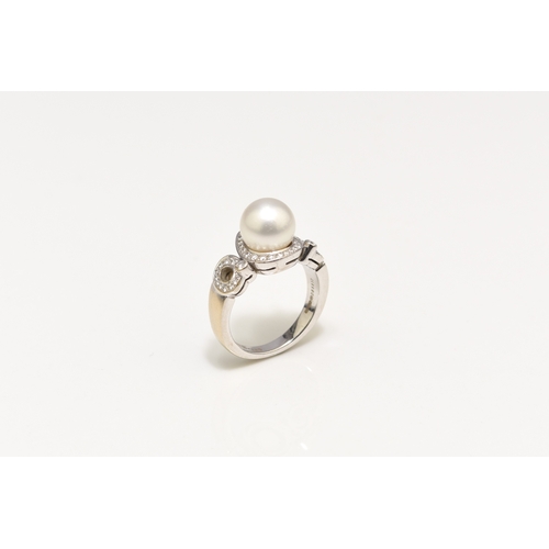 26 - A De Beers 18ct white gold cultured pearl and diamond ring, designed as a central single cultured pe... 