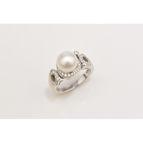 26 - A De Beers 18ct white gold cultured pearl and diamond ring, designed as a central single cultured pe... 
