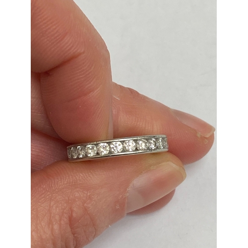 27 - A De Beers platinum diamond full eternity ring, the brilliant cut diamonds channel set in platinum, ... 