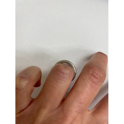 27 - A De Beers platinum diamond full eternity ring, the brilliant cut diamonds channel set in platinum, ... 