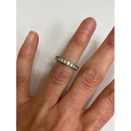 27 - A De Beers platinum diamond full eternity ring, the brilliant cut diamonds channel set in platinum, ... 