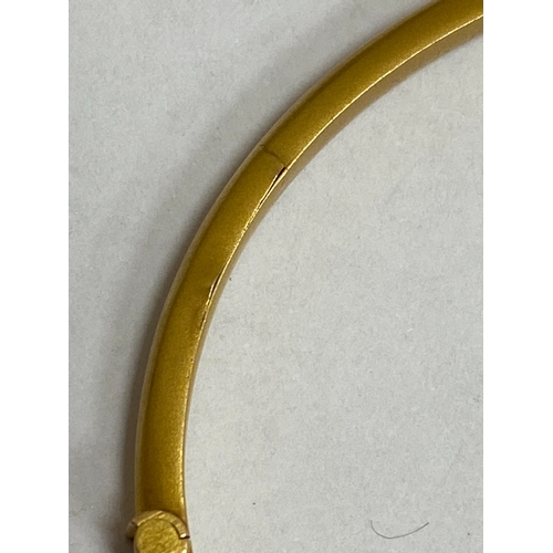 28 - An opal, diamond and red paste bangle, designed as a central round cabochon opal flanked to each sid... 