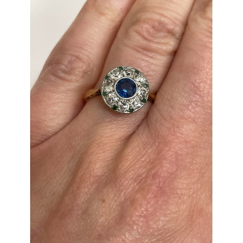 29 - An early-mid 20th century sapphire, diamond and emerald cluster ring, designed as a central round mi... 