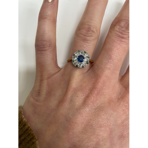 29 - An early-mid 20th century sapphire, diamond and emerald cluster ring, designed as a central round mi... 