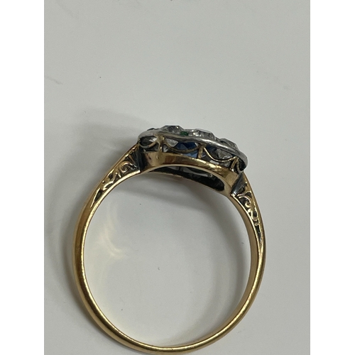 29 - An early-mid 20th century sapphire, diamond and emerald cluster ring, designed as a central round mi... 
