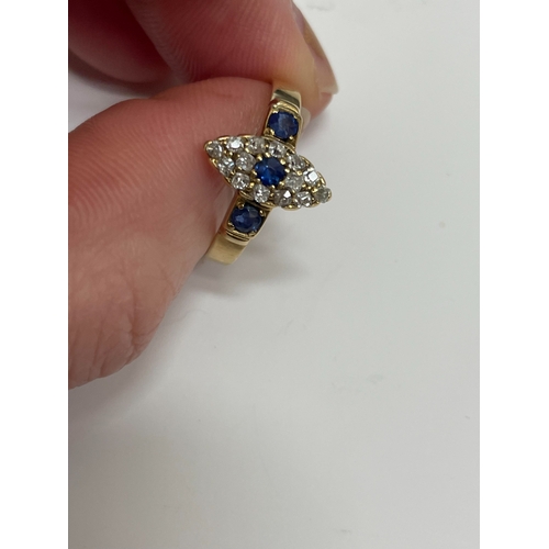 30 - An 18ct gold Edwardian sapphire and diamond ring, designed as a central round cut sapphire claw set ... 