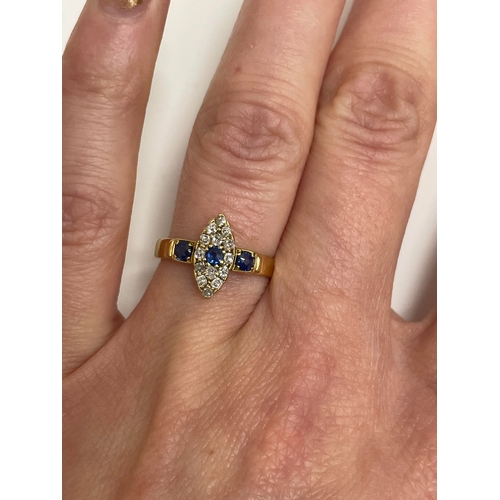 30 - An 18ct gold Edwardian sapphire and diamond ring, designed as a central round cut sapphire claw set ... 