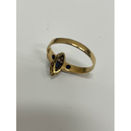 30 - An 18ct gold Edwardian sapphire and diamond ring, designed as a central round cut sapphire claw set ... 