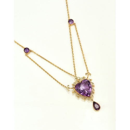 31 - An amethyst pendant necklace, designed as a heart shaped faceted amethyst within a cannetille scroll... 