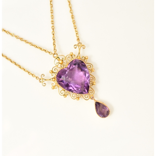31 - An amethyst pendant necklace, designed as a heart shaped faceted amethyst within a cannetille scroll... 