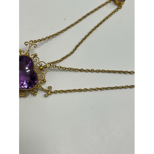 31 - An amethyst pendant necklace, designed as a heart shaped faceted amethyst within a cannetille scroll... 