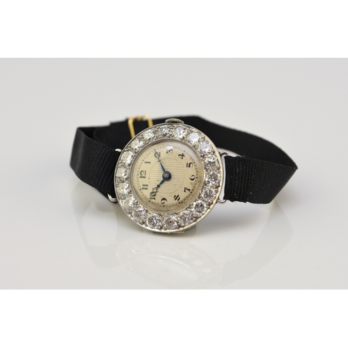 34 - An Art Deco diamond set cocktail watch, the circular silvered dial with black Roman numerals mounted... 