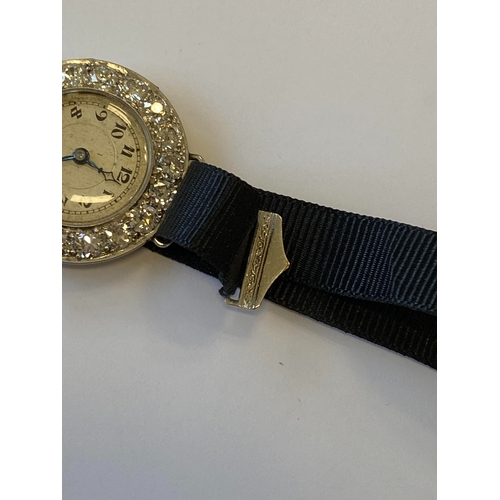 34 - An Art Deco diamond set cocktail watch, the circular silvered dial with black Roman numerals mounted... 