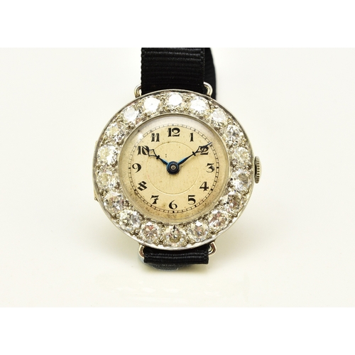 34 - An Art Deco diamond set cocktail watch, the circular silvered dial with black Roman numerals mounted... 