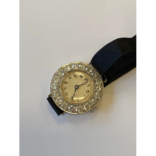 34 - An Art Deco diamond set cocktail watch, the circular silvered dial with black Roman numerals mounted... 