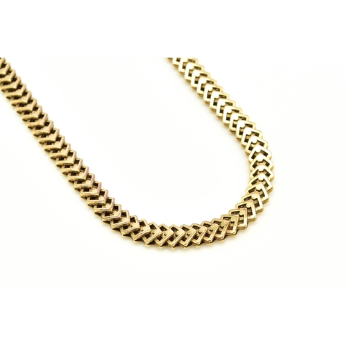 35 - A 14ct yellow gold decorative link necklace, the stylised interlocking openwork square links with in... 