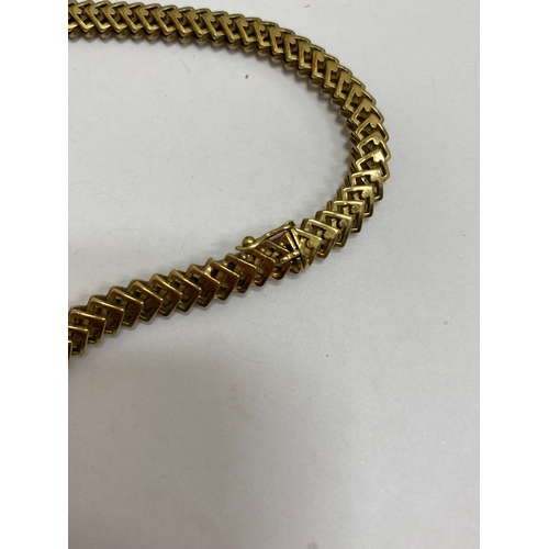 35 - A 14ct yellow gold decorative link necklace, the stylised interlocking openwork square links with in... 