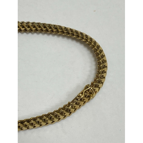 35 - A 14ct yellow gold decorative link necklace, the stylised interlocking openwork square links with in... 