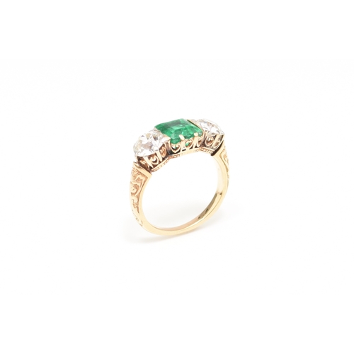 37 - A late 19th / early 20th century three stone emerald and diamond ring, designed as a central square ... 