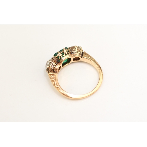 37 - A late 19th / early 20th century three stone emerald and diamond ring, designed as a central square ... 