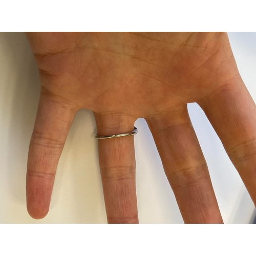 38 - A French Art Deco coral and diamond ring, designed as a single oval cabochon coral mounted within gr... 