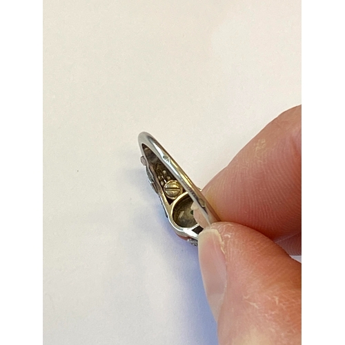 38 - A French Art Deco coral and diamond ring, designed as a single oval cabochon coral mounted within gr... 