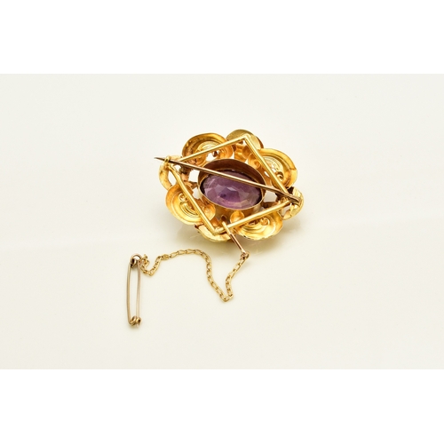 39 - A Victorian amethyst brooch, designed as a central oval mixed cut amethyst claw set within a yellow ... 