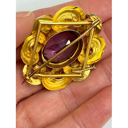 39 - A Victorian amethyst brooch, designed as a central oval mixed cut amethyst claw set within a yellow ... 