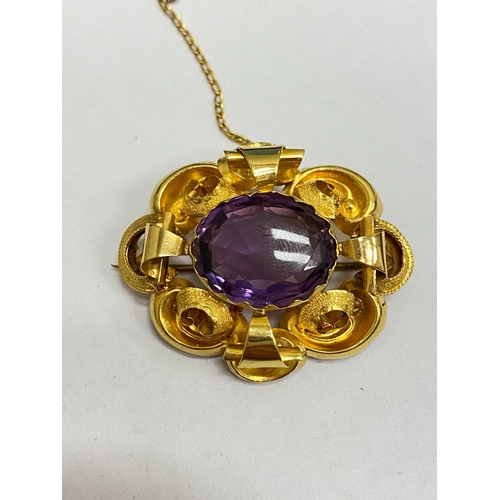 39 - A Victorian amethyst brooch, designed as a central oval mixed cut amethyst claw set within a yellow ... 