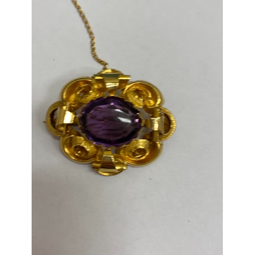 39 - A Victorian amethyst brooch, designed as a central oval mixed cut amethyst claw set within a yellow ... 