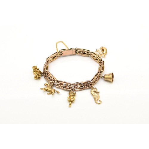 40 - A rose metal decorative link bracelet with attached charms, the rose metal bracelet with integral cl... 
