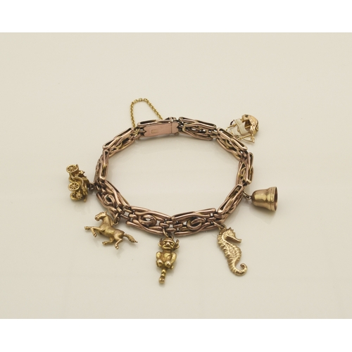 40 - A rose metal decorative link bracelet with attached charms, the rose metal bracelet with integral cl... 