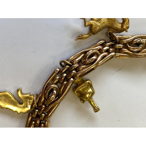 40 - A rose metal decorative link bracelet with attached charms, the rose metal bracelet with integral cl... 