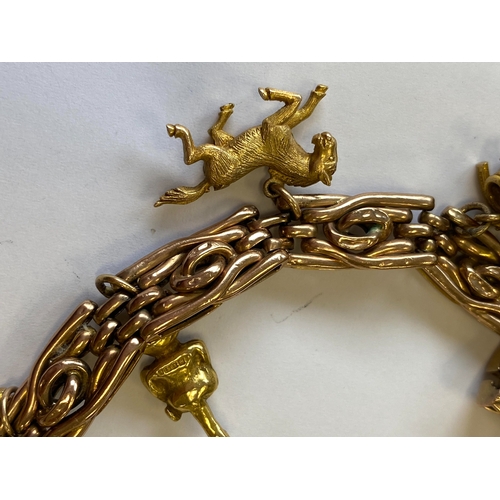 40 - A rose metal decorative link bracelet with attached charms, the rose metal bracelet with integral cl... 