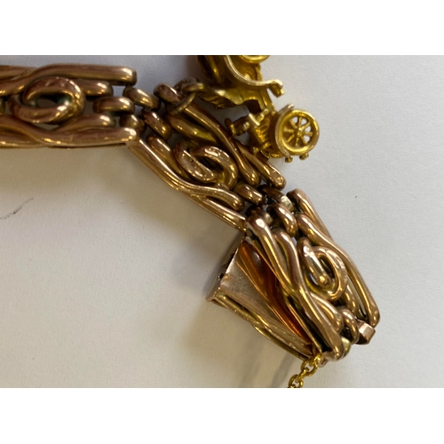 40 - A rose metal decorative link bracelet with attached charms, the rose metal bracelet with integral cl... 