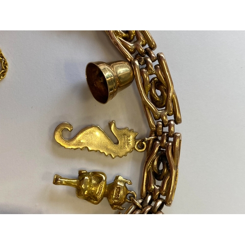 40 - A rose metal decorative link bracelet with attached charms, the rose metal bracelet with integral cl... 