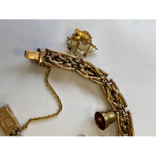 40 - A rose metal decorative link bracelet with attached charms, the rose metal bracelet with integral cl... 